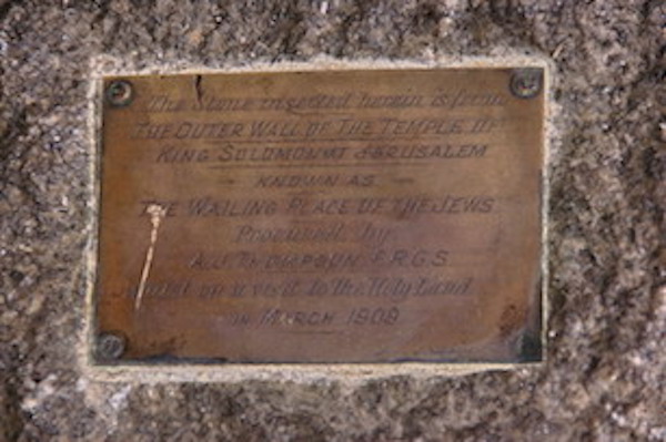 Brass plate on the rough ashlar